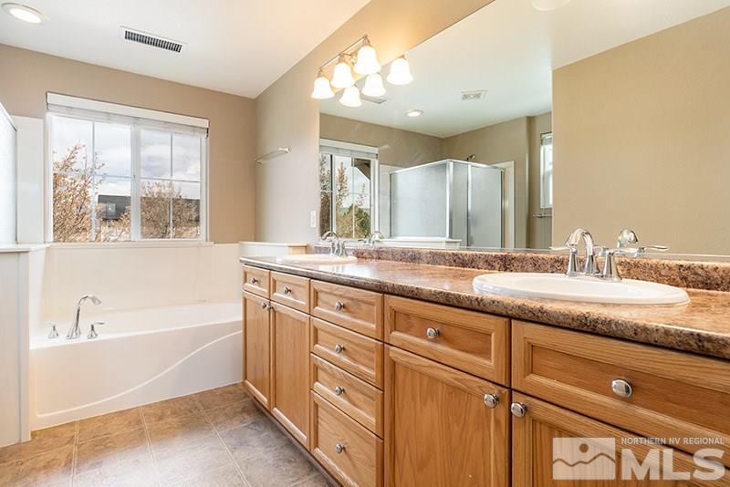 2010 Long Hollow Drive Reno, NV 89521 - Photo 16 of 24 a bath room with a sink double vanity and a mirror