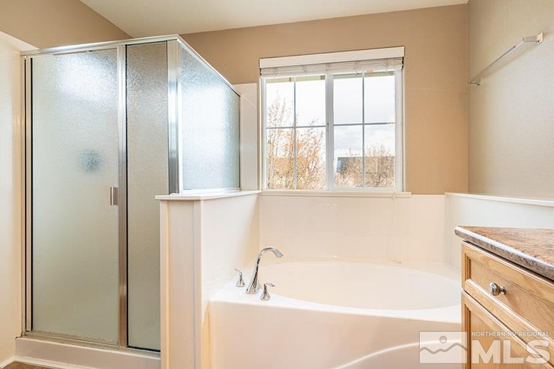 2010 Long Hollow Drive Reno, NV 89521 - Photo 17 of 24 a bathroom with a bathtub and a shower