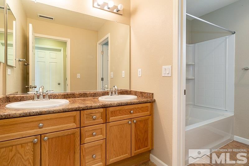2010 Long Hollow Drive Reno, NV 89521 - Photo 20 of 24 a bathroom with a granite countertop sink and a mirror
