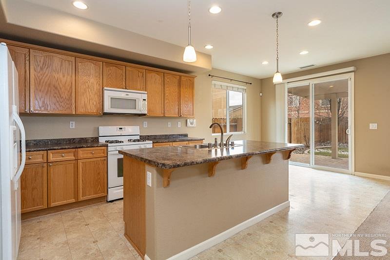 2010 Long Hollow Drive Reno, NV 89521 - Photo 7 of 24 a kitchen with stainless steel appliances granite countertop a stove a sink and a microwave