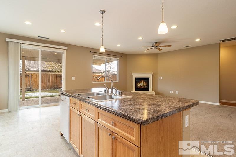 2010 Long Hollow Drive Reno, NV 89521 - Photo 10 of 24 a kitchen with kitchen island a sink granite counter tops and a view of living room
