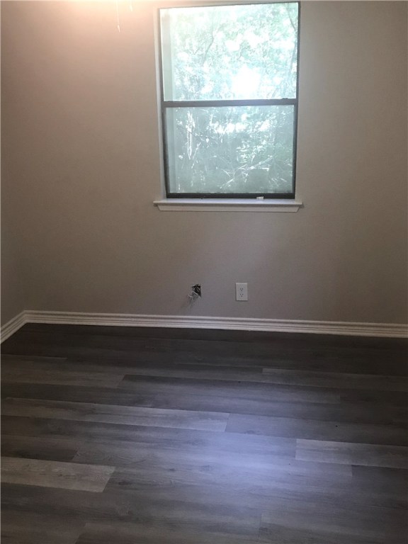 1610 Waterloo Trail, Unit B Austin, TX 78704 - Photo 11 of 23 a view of empty room with wooden floor and a window