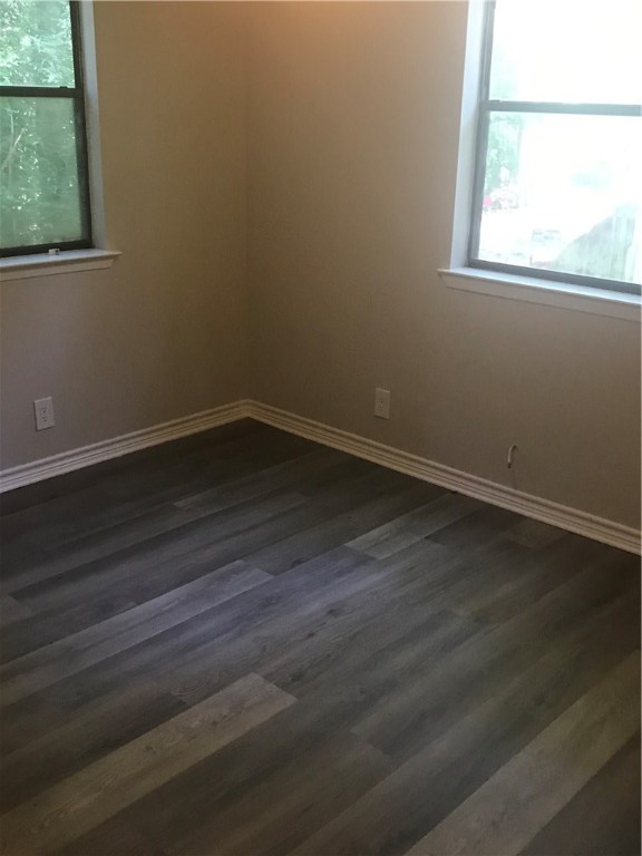 1610 Waterloo Trail, Unit B Austin, TX 78704 - Photo 12 of 23 an empty room with wooden floor and windows