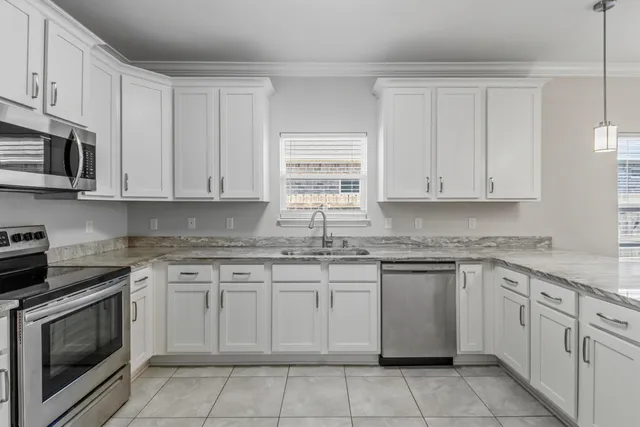 a view of a kitchen with granite countertop cabinets