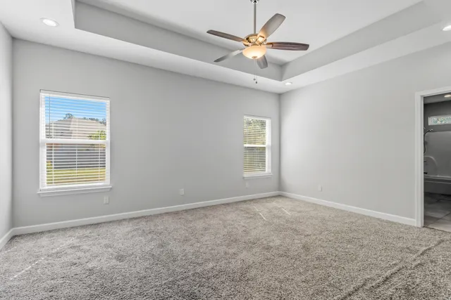 a view of entryway and hall with a chandelier fan