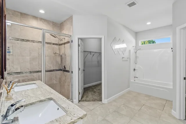 a bathroom with a double vanity sink mirror and double