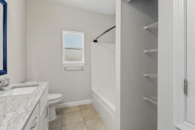 an empty room with fan and windows