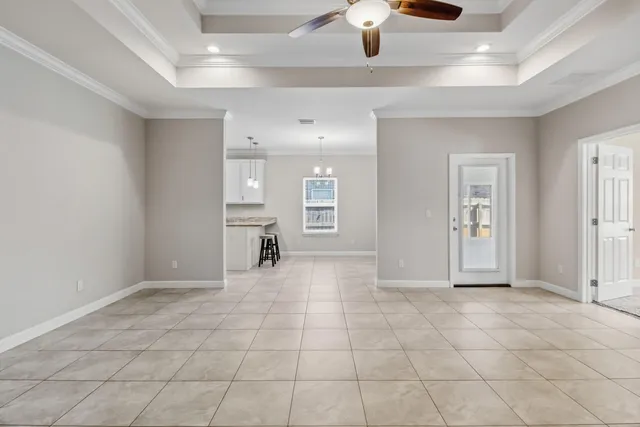 a view of kitchen with granite countertop cabinets and window