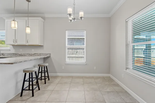 a kitchen with stainless steel appliances granite countertop a stove a sink a microwave and a refrigerator