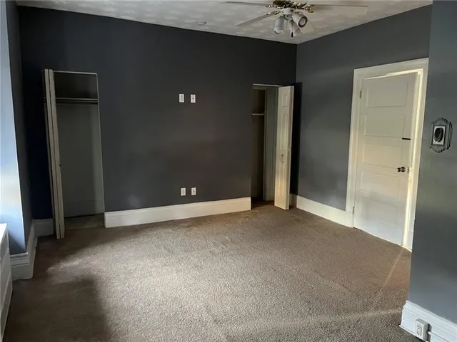 wooden floor and a chandelier fan in a room