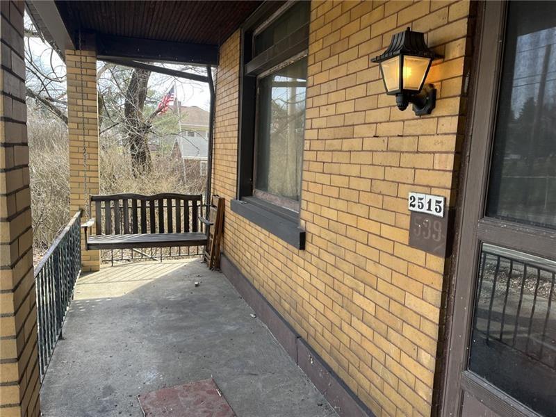 2515 Mt Troy Road Pittsburgh, PA 15212 - Photo 2 of 27 a view of a porch with wooden floor and floor to ceiling window
