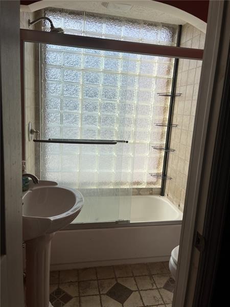 2515 Mt Troy Road Pittsburgh, PA 15212 - Photo 22 of 27 a bathroom with a granite countertop sink a mirror and a shower