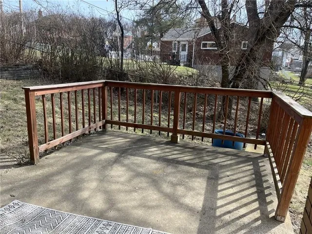 a view of backyard with deck and outdoor seating
