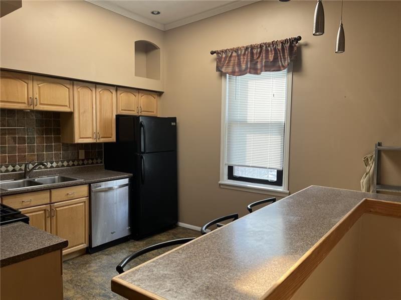2515 Mt Troy Road Pittsburgh, PA 15212 - Photo 5 of 27 a kitchen with a refrigerator and a sink