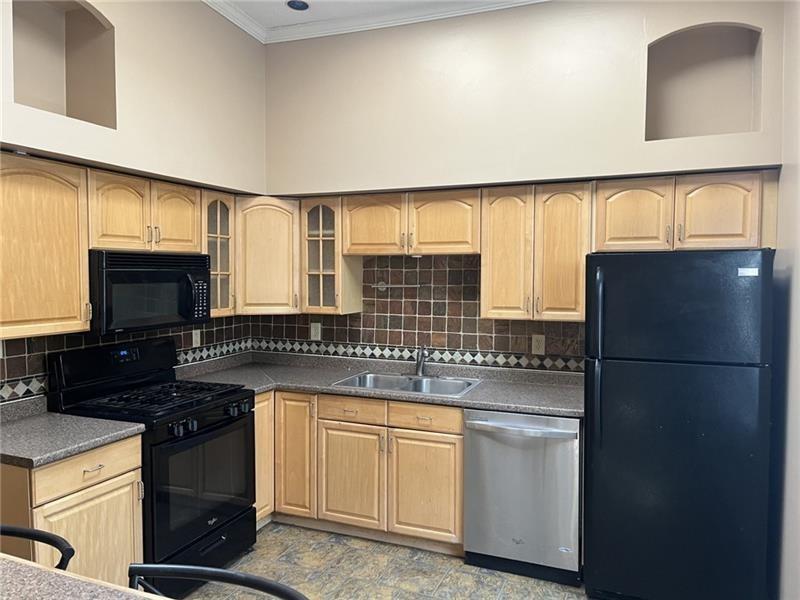 2515 Mt Troy Road Pittsburgh, PA 15212 - Photo 6 of 27 a kitchen with a stove a sink and a refrigerator