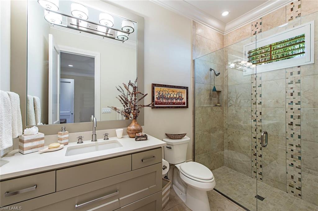 2178 Miramonte Way Naples, FL 34105 - Photo 11 of 21 a bathroom with a sink a toilet a shower and a mirror