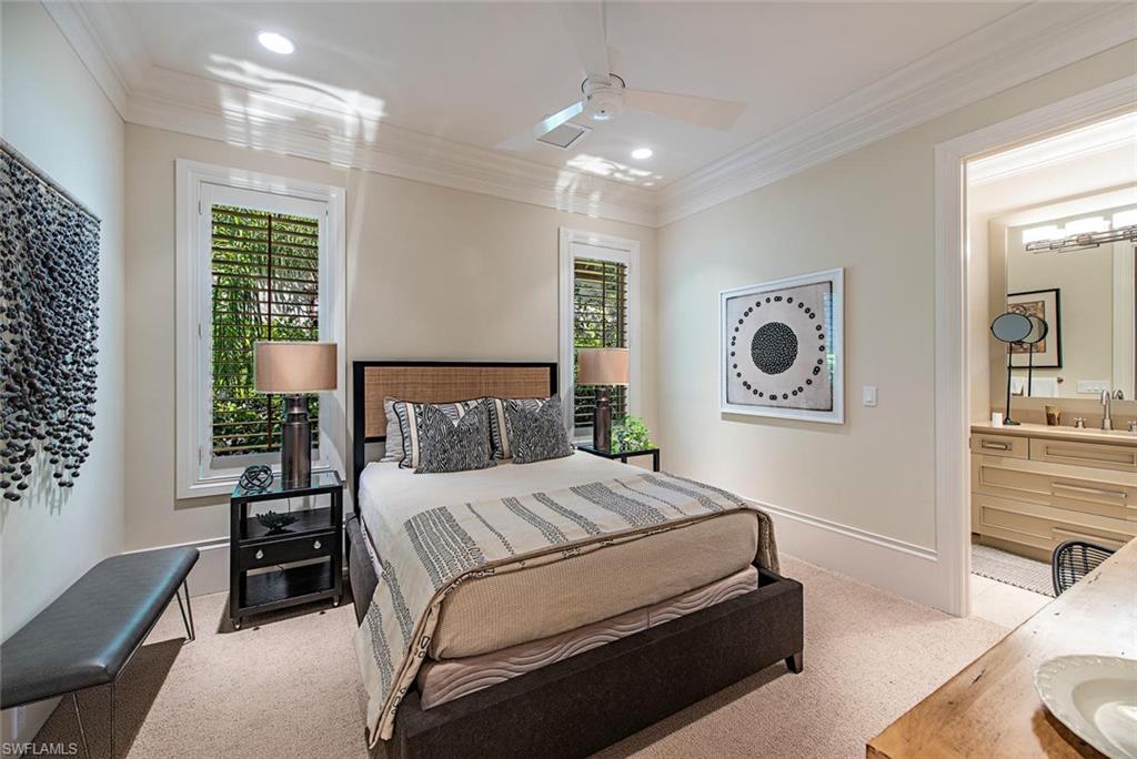 2178 Miramonte Way Naples, FL 34105 - Photo 12 of 21 a bedroom with a large bed and a chandelier