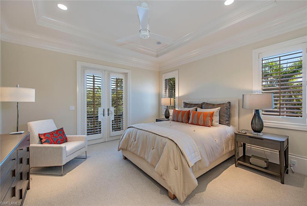 2178 Miramonte Way Naples, FL 34105 - Photo 14 of 21 a bedroom with a bed and a couch