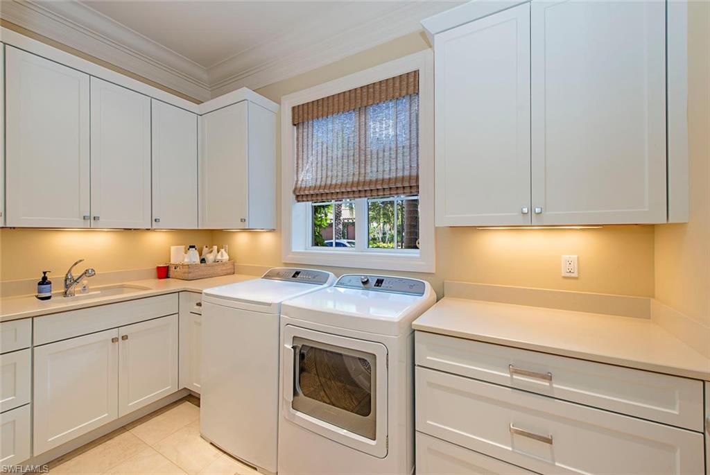 2178 Miramonte Way Naples, FL 34105 - Photo 17 of 21 a kitchen with a sink stove and cabinets