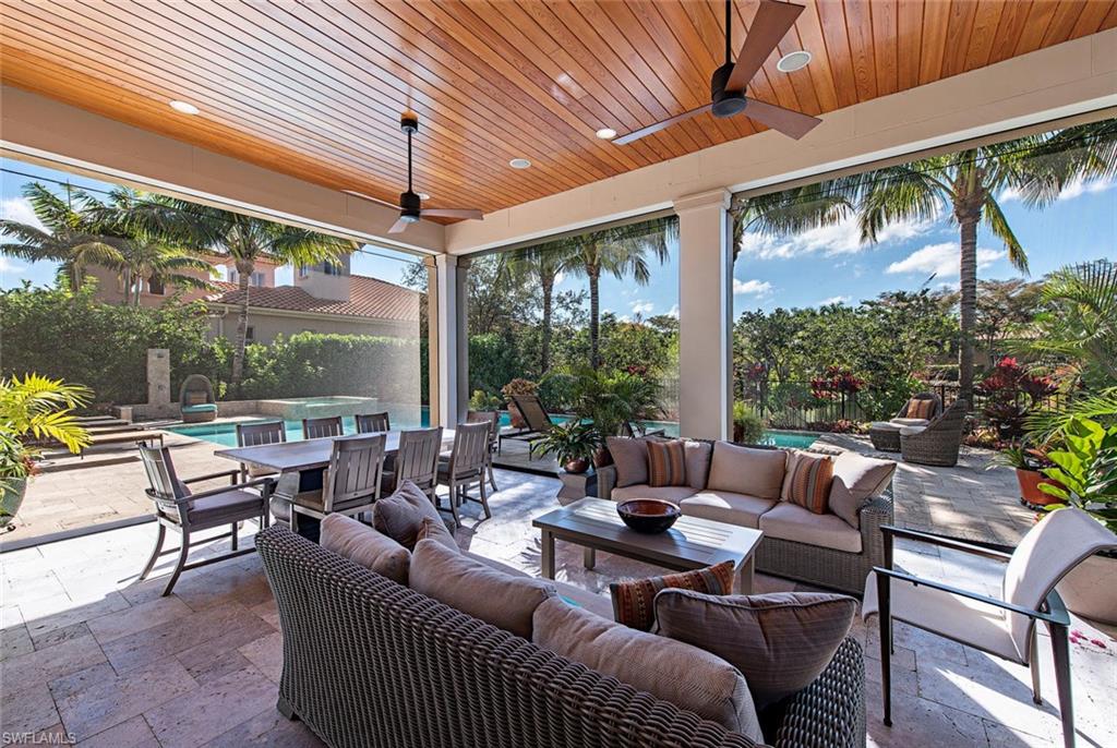 2178 Miramonte Way Naples, FL 34105 - Photo 18 of 21 a living room with patio furniture and a floor to ceiling window