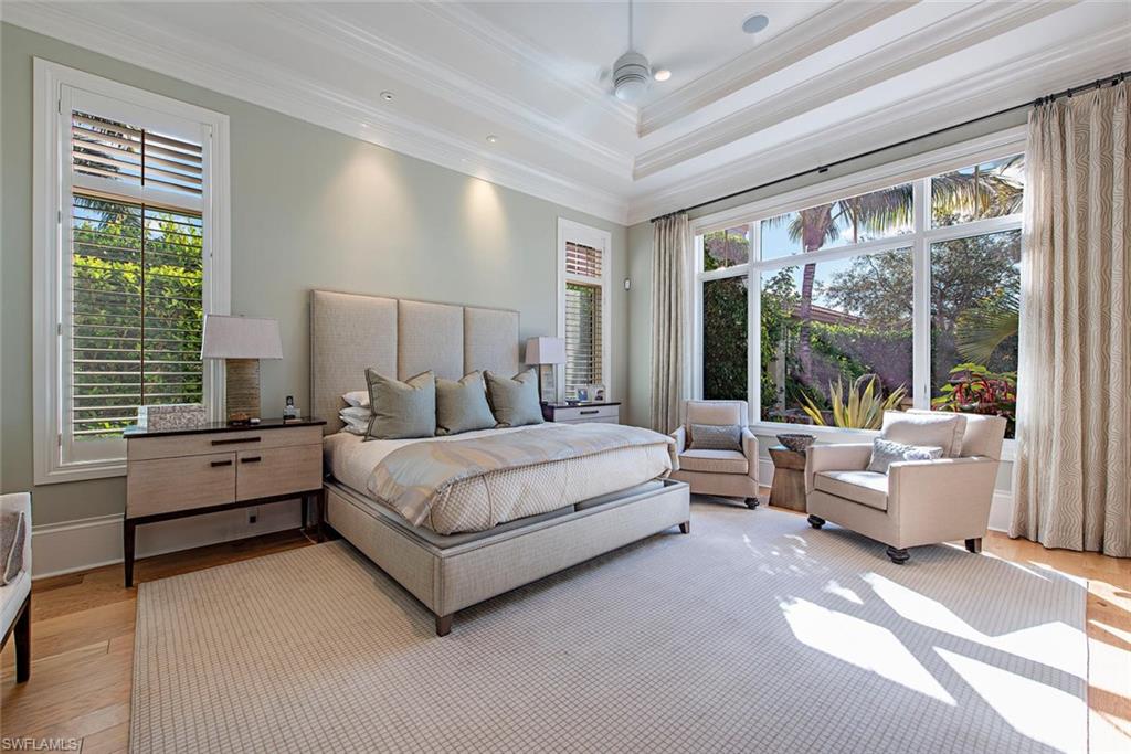 2178 Miramonte Way Naples, FL 34105 - Photo 8 of 21 a bedroom with a large bed and a large window