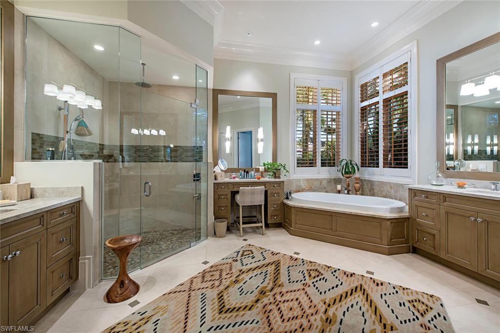 2178 Miramonte Way Naples, FL 34105 - Photo 9 of 21 a large spacious bathroom with a double vanity sink a large mirror and a bathtub
