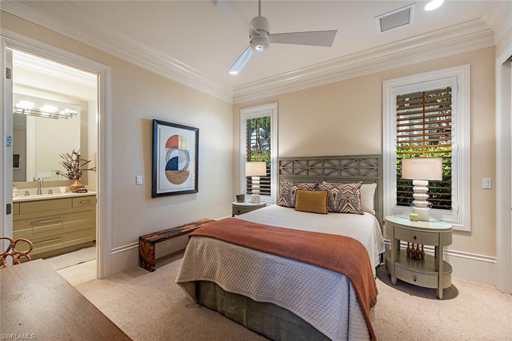 2178 Miramonte Way Naples, FL 34105 - Photo 10 of 21 a bedroom with a bed a mirror and furniture