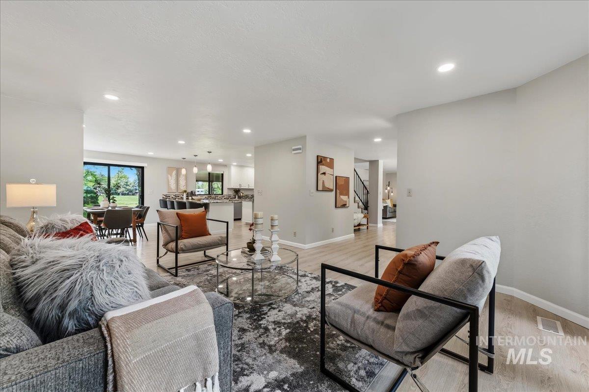 599 Pebble Beach Way Eagle, ID 83616 - Photo 7 of 44 Spacious living area featuring light wood-finish flooring, recessed lighting, and a neutral color palette