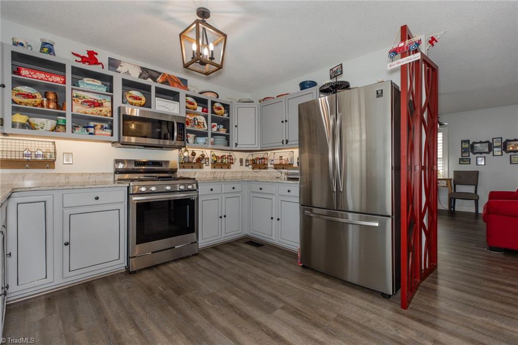 4243 Hunters Run Trinity, NC 27370 - Photo 14 of 33 Updated appliances include this gas cooktop, dishwasher and microwave