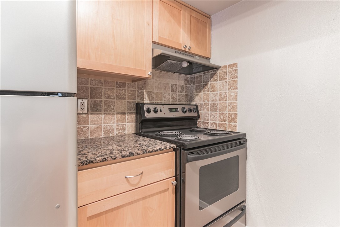 3627 Menchaca Road, Unit 112 Austin, TX 78704 - Photo 9 of 25 Granite counter tops with tile backsplash