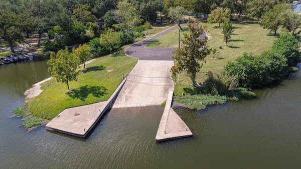 an aerial view of a house with swimming pool and lake view