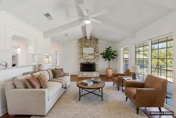 a living room with furniture or chandelier and a fireplace