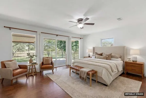 a bedroom with a bed a couch and a large window