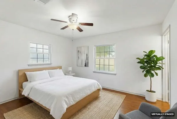 a bedroom with a bed and a potted plant