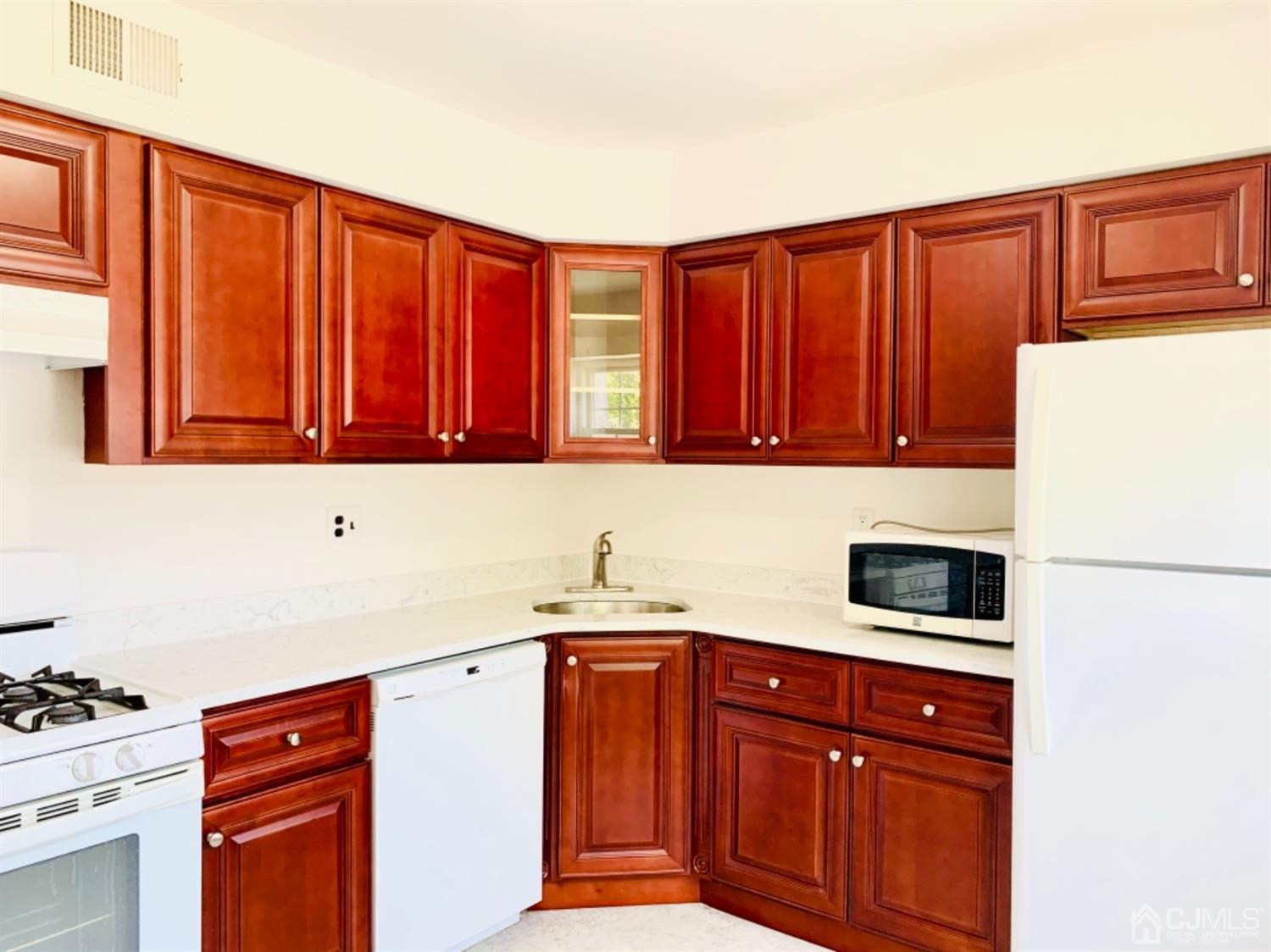 8401 Hana Road Edison, NJ 08817 - Photo 19 of 41 a kitchen with stainless steel appliances a refrigerator and a sink