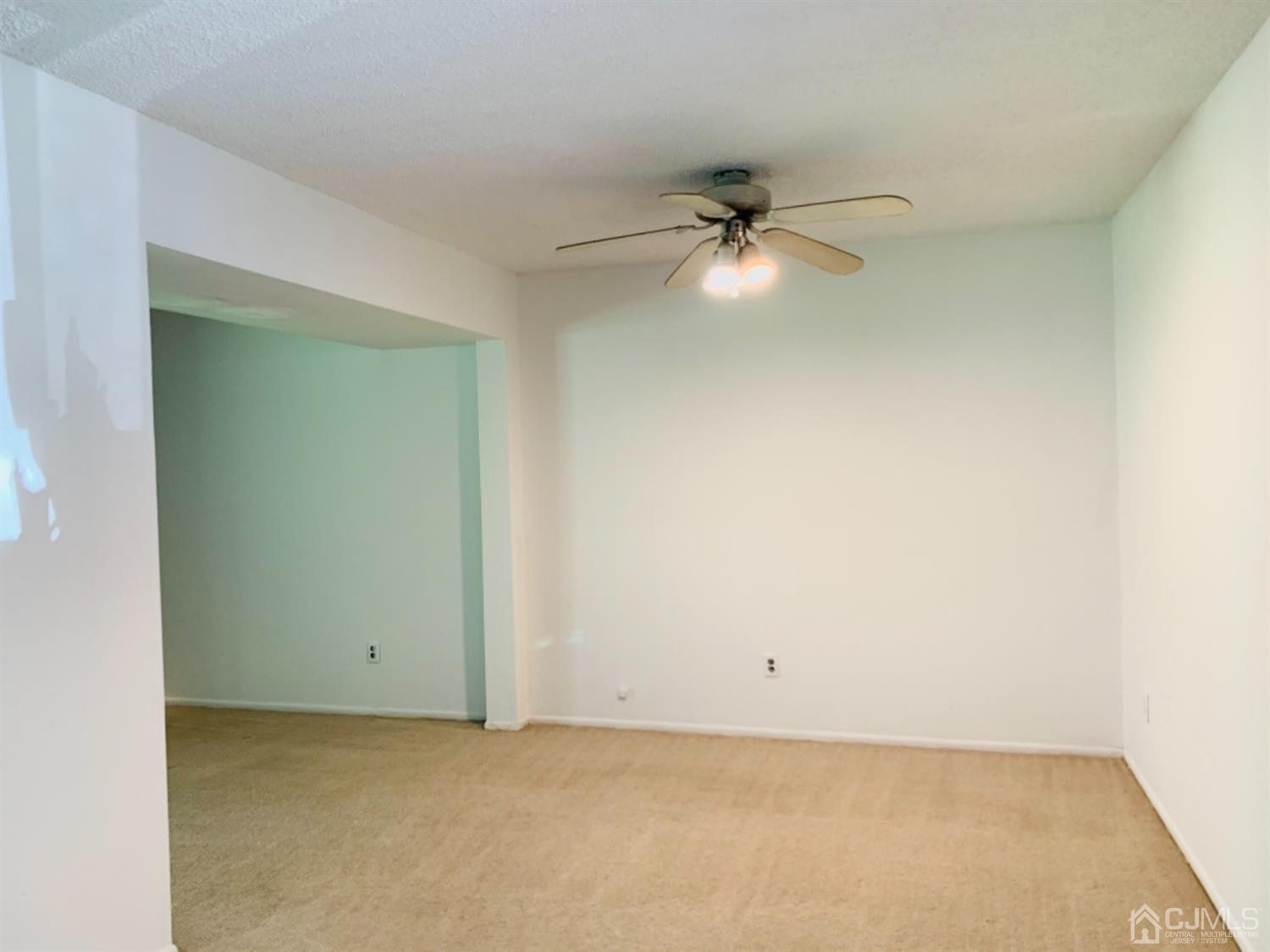 8401 Hana Road Edison, NJ 08817 - Photo 24 of 41 an empty room with a ceiling fan and a window