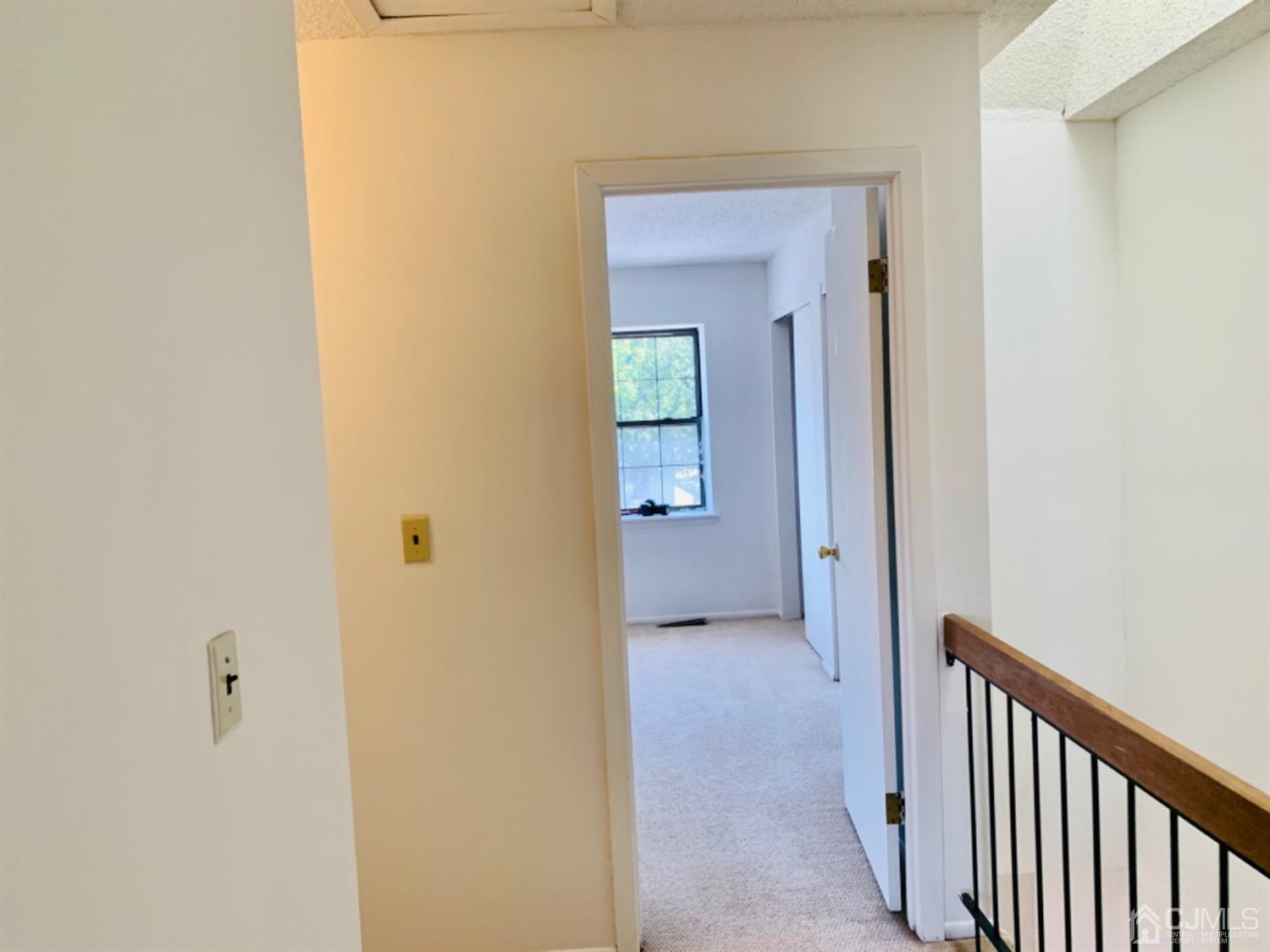 8401 Hana Road Edison, NJ 08817 - Photo 27 of 41 a view of a hallway with wooden floor