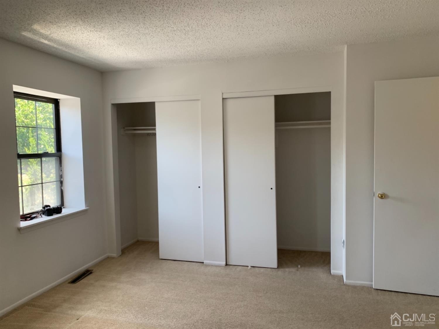 8401 Hana Road Edison, NJ 08817 - Photo 38 of 41 an empty room with windows and closet