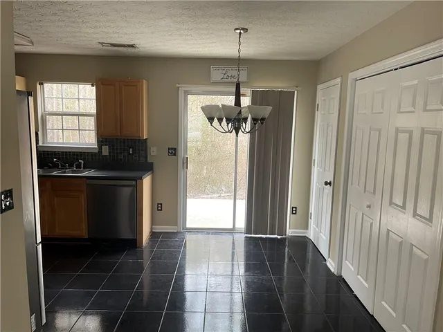 a kitchen with a refrigerator a sink and cabinets