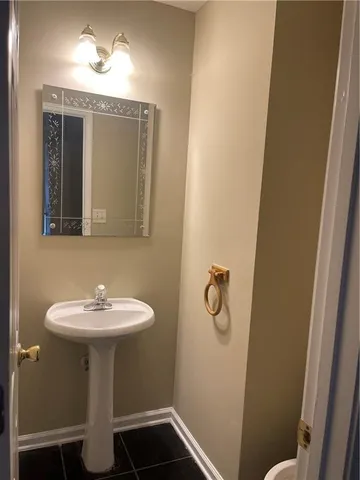 a bathroom with a sink a mirror and toilet