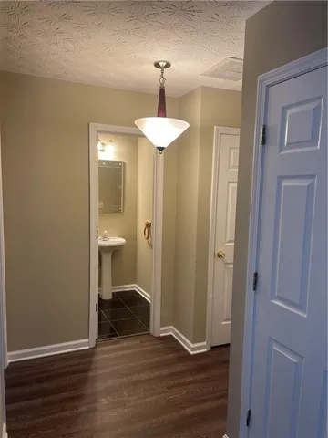 a view of a room with wooden floor table and chair
