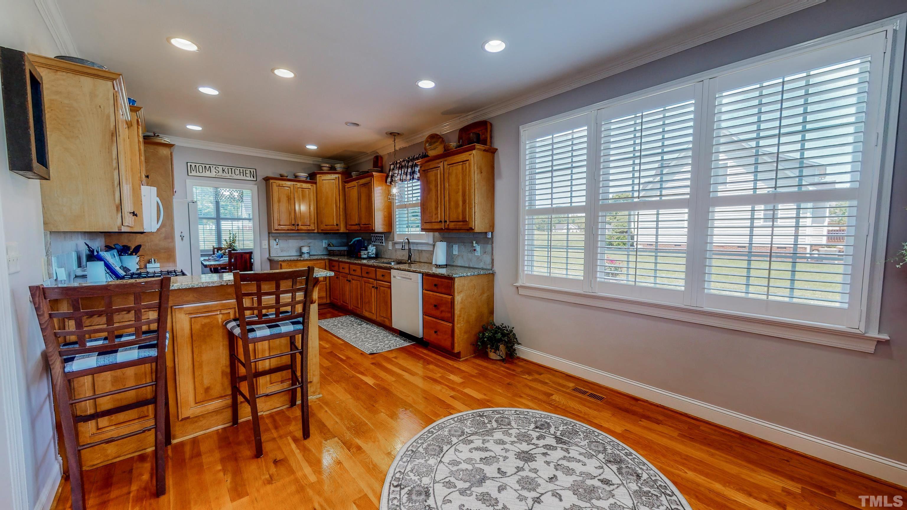 103 Derwin Drive Timberlake, NC 27583 - Photo 12 of 57 a kitchen with stainless steel appliances granite countertop sink stove and white cabinets