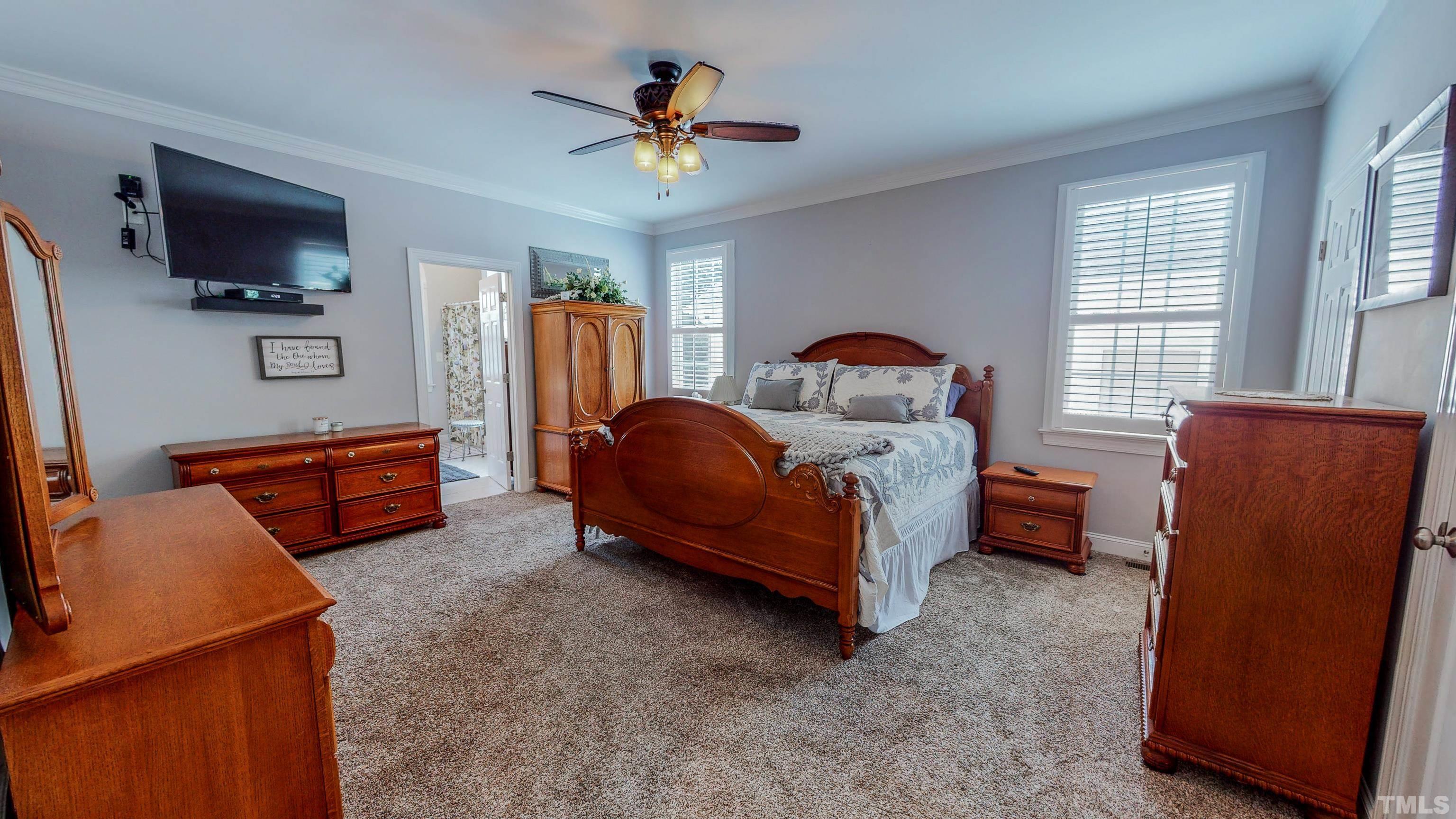 103 Derwin Drive Timberlake, NC 27583 - Photo 19 of 57 a bedroom with furniture and flat screen tv