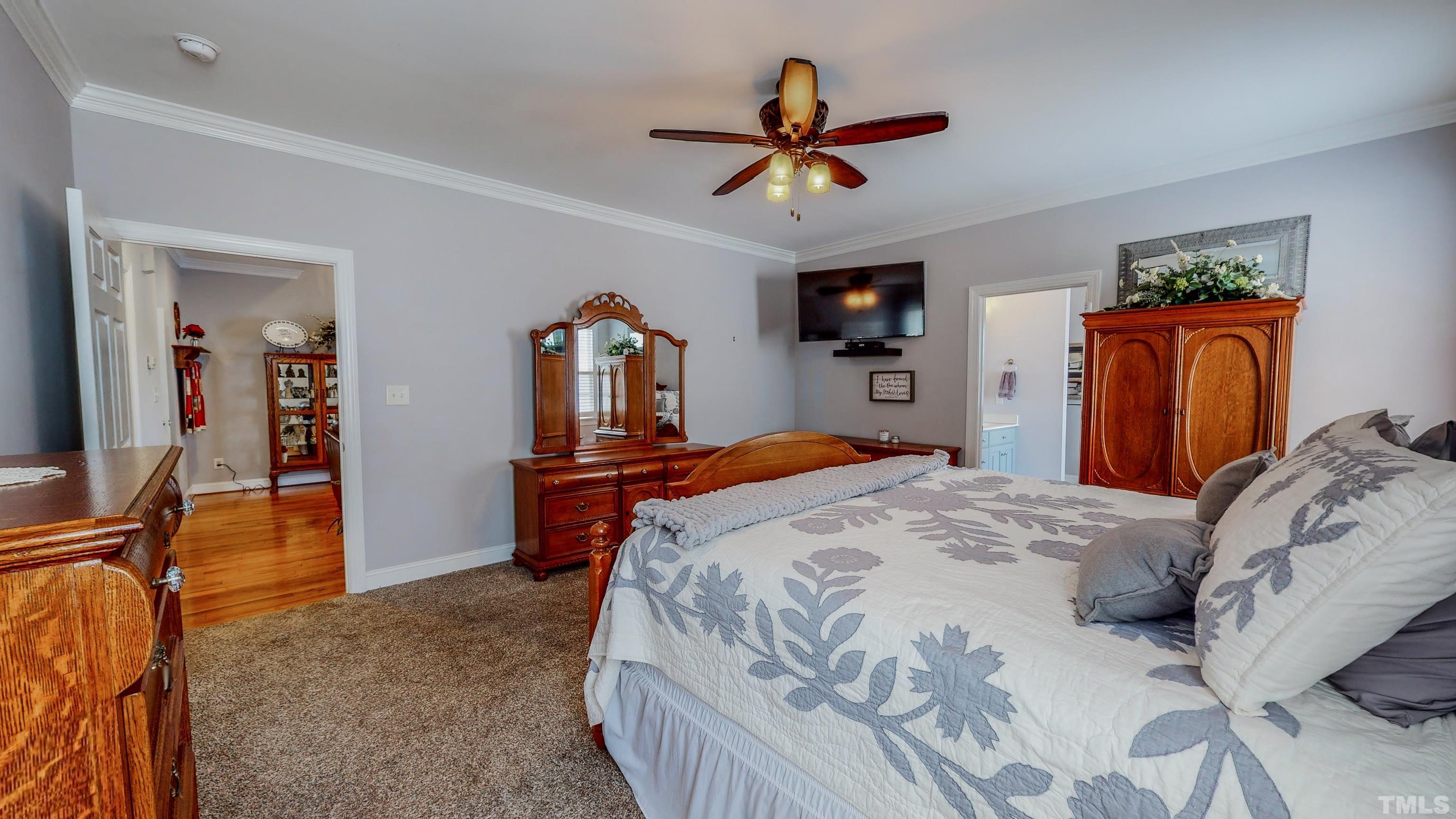 103 Derwin Drive Timberlake, NC 27583 - Photo 20 of 57 a bed room with a bed and a chandelier