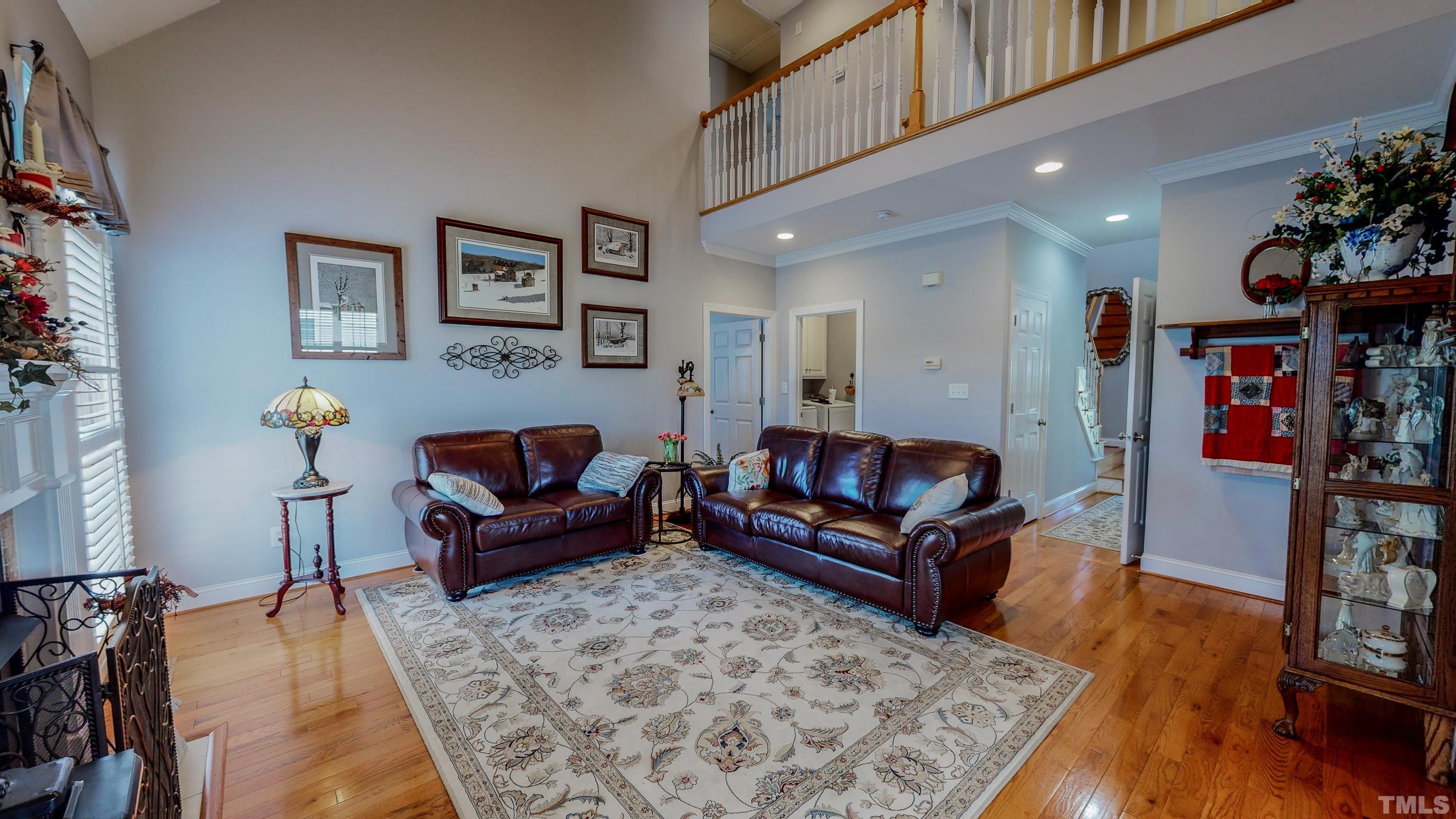 103 Derwin Drive Timberlake, NC 27583 - Photo 2 of 57 a living room with furniture and wooden floor