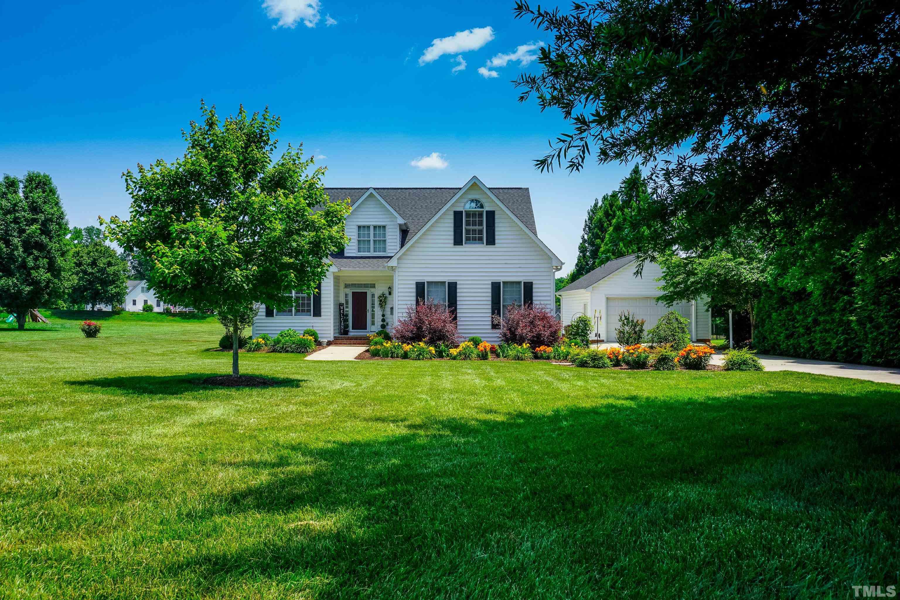 103 Derwin Drive Timberlake, NC 27583 - Photo 25 of 57 a front view of a house with a yard and trees