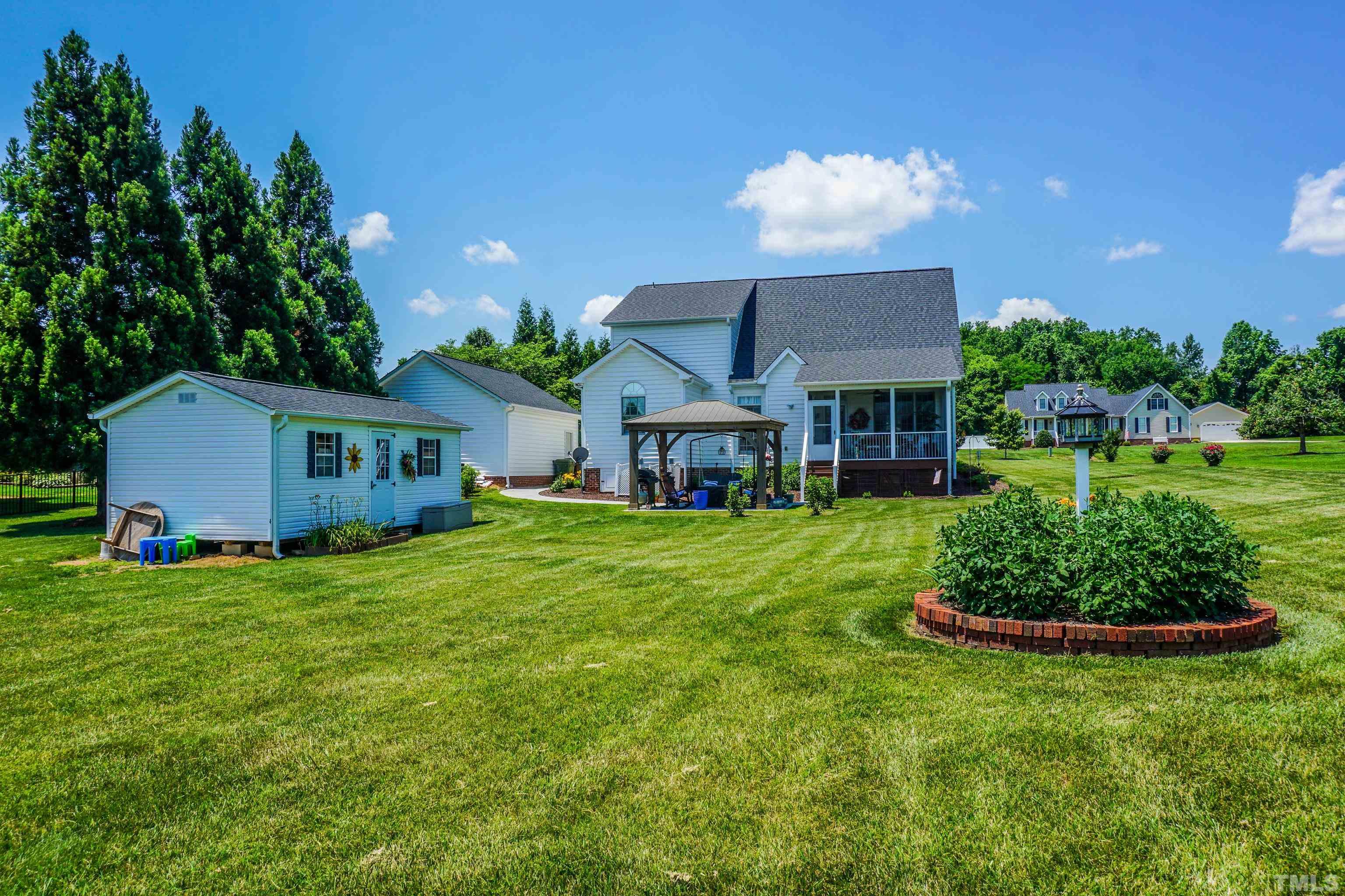 103 Derwin Drive Timberlake, NC 27583 - Photo 26 of 57 a front view of a house with a garden