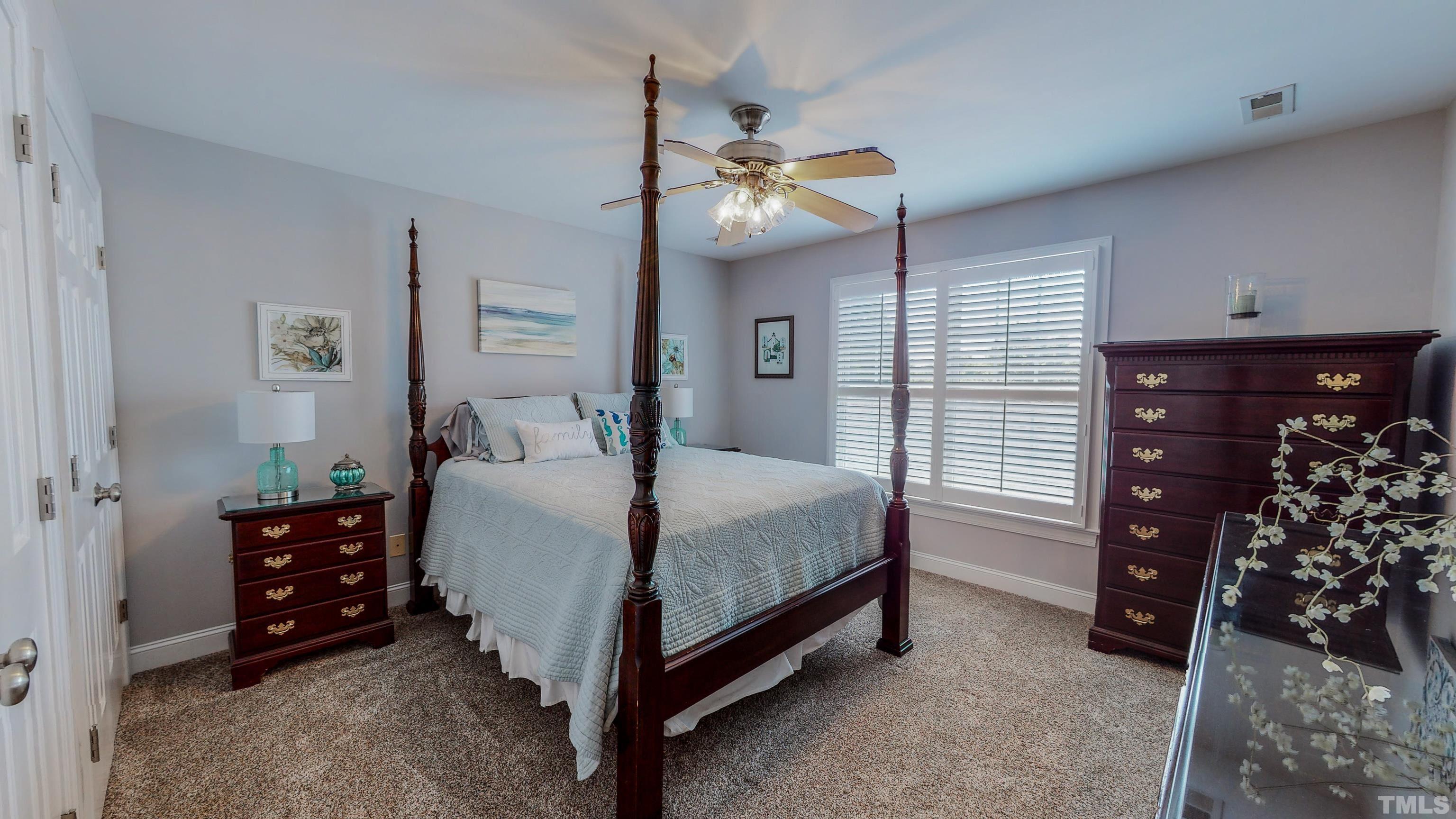 103 Derwin Drive Timberlake, NC 27583 - Photo 34 of 57 a bedroom with a bed and a ceiling fan