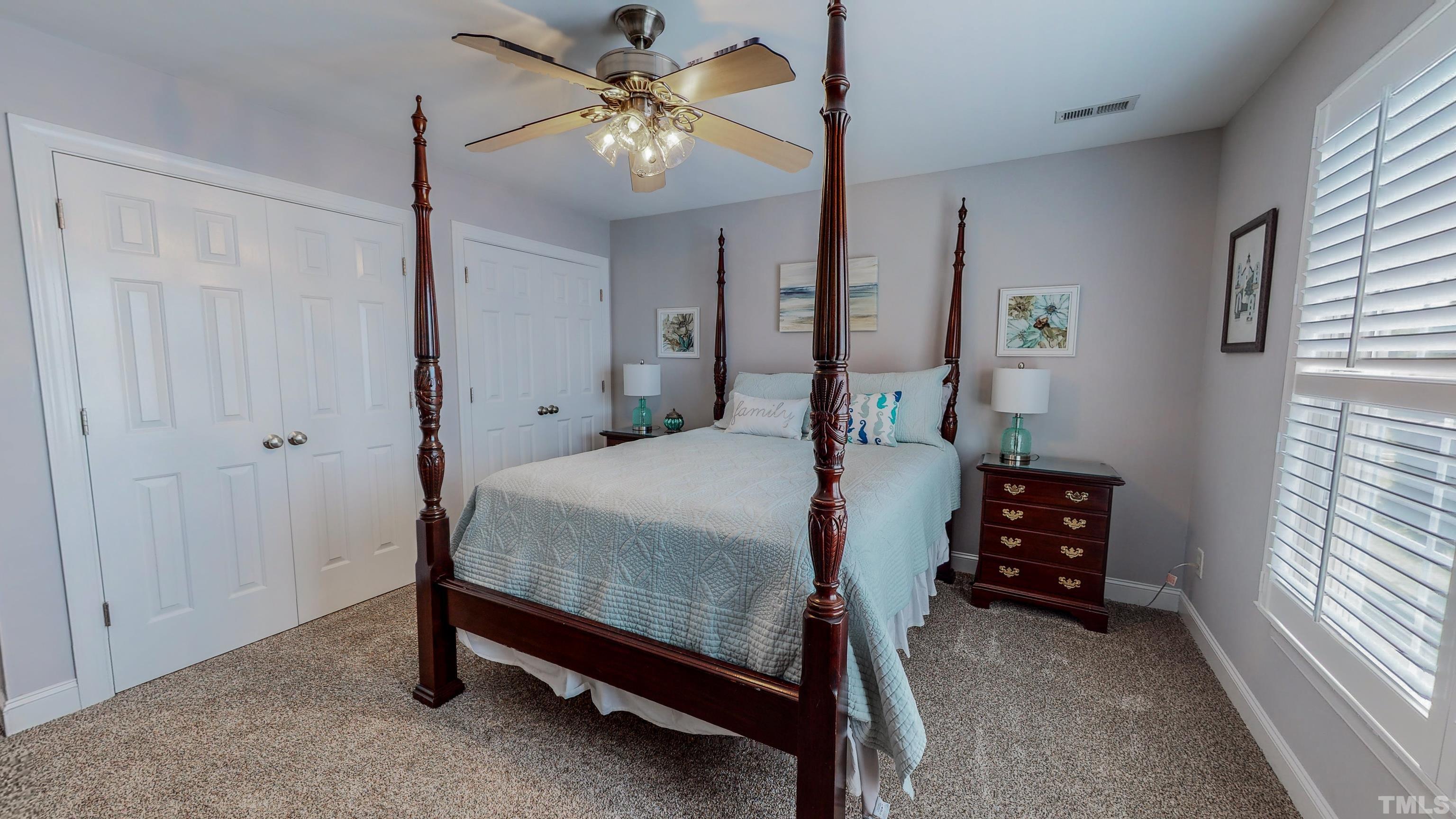 103 Derwin Drive Timberlake, NC 27583 - Photo 35 of 57 a bedroom with a bed and a chandelier