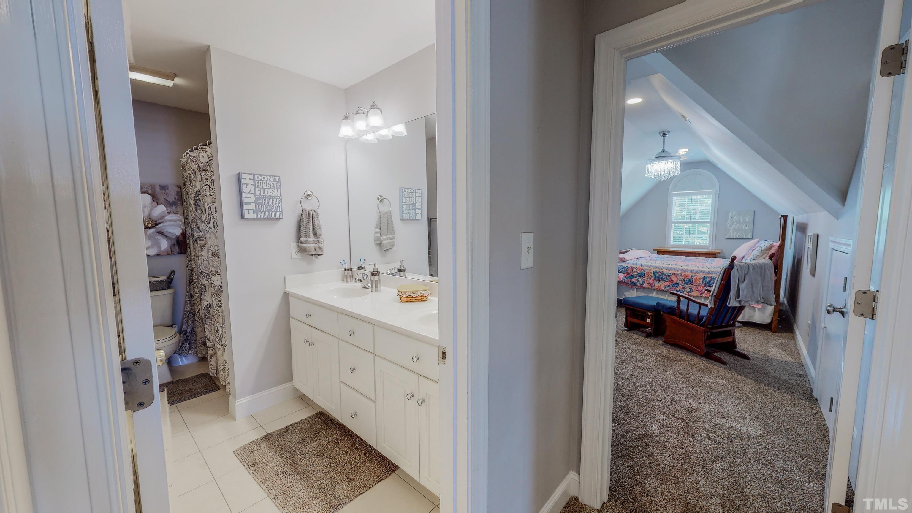 103 Derwin Drive Timberlake, NC 27583 - Photo 38 of 57 a en suite bathroom with a double vanity sink and a mirror